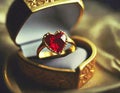 Red heart shaped gem stone on golden ring in gift box