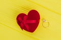 Red heart shaped gift box and golden ring. Royalty Free Stock Photo