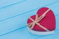 Red heart shaped gift box over blue background. Royalty Free Stock Photo