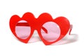 Red heart-shaped glasses on white