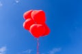 Red heart shaped helium balloons flying in the sky Royalty Free Stock Photo