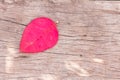 Red, heart-shaped leaves, on the background of wood.