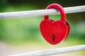 A Red heart shaped lock as a symbol of love. Padlock heart on a green background. Royalty Free Stock Photo