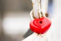 Red heart-shaped lock on bridge. Love locks on bridge. Lock in the shape of a heart. The closed red padlock in the form of heart Royalty Free Stock Photo