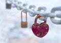 A red heart-shaped lock hangs from the bridge chain. The wedding custom is a symbol of eternal love.