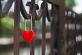 Red heart-shaped locks are hanging on the bridge lovers Royalty Free Stock Photo