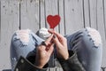 Red heart shaped lollipop in a trendy fashionable woman`s hands, top view. Royalty Free Stock Photo