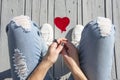 Red heart shaped lollipop in a trendy fashionable woman hand, top view. Royalty Free Stock Photo