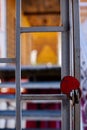 red heart shaped metal padlock on lattice door