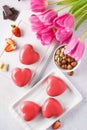 Red heart shaped mousse cakes with berries and chocolate. Royalty Free Stock Photo