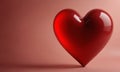 red heart-shaped object with glossy surface stands against pink background, casting shadow on the surface. Royalty Free Stock Photo