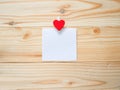 Red heart shaped peg and blank paper Royalty Free Stock Photo