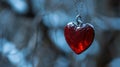 A red heart shaped pendant hanging from a chain on tree branch, AI Royalty Free Stock Photo