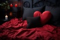 red heart shaped pillow on black and red silk bed in bedroom with candles Royalty Free Stock Photo