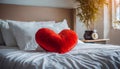 Red heart-shaped pillow on top of bed, Soft and cozy. Minimalistic bedroom Royalty Free Stock Photo