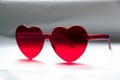 Red heart shaped sunglasses on light background, closeup Royalty Free Stock Photo