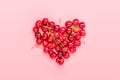 red heart shaped sweet cherry berries isolated on trendy pink background Top view Flat lay Creative concept Holiday card Healthy Royalty Free Stock Photo