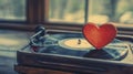 Red heart shaped vinyl record on black turntable with needle and platter in view Royalty Free Stock Photo