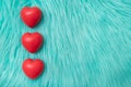 The red Heart shapes on abstract turquoise fur Royalty Free Stock Photo