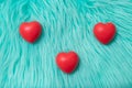 The red Heart shapes on abstract turquoise fur Royalty Free Stock Photo