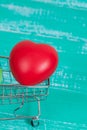 heart sign in shopping cart on color wood Royalty Free Stock Photo