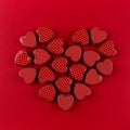 Red heart of small hearts on deep red paper background. Valentine day.