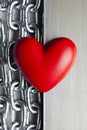 Red heart on steel chains and aluminum plate background Royalty Free Stock Photo