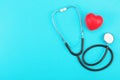 Red heart and stethoscope on a blue background. Royalty Free Stock Photo