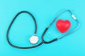 Red heart and stethoscope on a blue background. Royalty Free Stock Photo