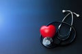 Red heart and stethoscope on blue paper. Flat lay essential items for doctor using treat and care patient in hospital Royalty Free Stock Photo