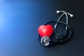 Red heart and stethoscope on blue paper. Flat lay essential items for doctor using treat and care patient in hospital Royalty Free Stock Photo