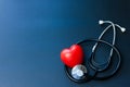 Red heart and stethoscope on blue paper. Flat lay essential items for doctor using treat and care patient in hospital Royalty Free Stock Photo