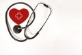 Red heart with Stethoscope and the icon of the medical red crosson white background texture.World health day, Healthcare and Royalty Free Stock Photo