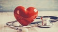 A red heart and a stethoscope on a light background, area for text Royalty Free Stock Photo