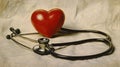 A red heart and a stethoscope on a light background, area for text Royalty Free Stock Photo