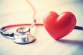 Red heart and stethoscope placed on table. This image can be used to represent healthcare, medical professions, or love Royalty Free Stock Photo
