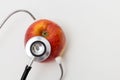 Red heart with a stethoscope on table. Isolated on white background. Studio lighting. Concept for healthy and medical Royalty Free Stock Photo