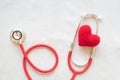 Red heart and stethoscope on white isolated background, copy space. Concept for heart health, cardiology, insurance plan, organ