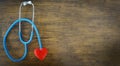 Red heart on stethoscope on wooden background / Check the heart medical for doctor is the patient pulse health concept Royalty Free Stock Photo