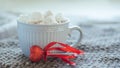 Red heart on a stick next to large cup with warm coffee or tea. Morning on Valentine`s Day. pleasant surprise gift for holiday Royalty Free Stock Photo