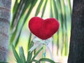 Red heart with stick and ribbon with natural background