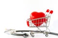 Red heart in a supermarket trolley and stethoscope. The concept of medicine and health insurance. Royalty Free Stock Photo