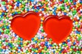 2 Red heart surrounded by colourful candy balls Royalty Free Stock Photo