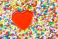 Red heart surrounded by colourful candy balls Royalty Free Stock Photo