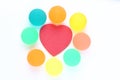 Red heart surrounded by colourful rubber ball