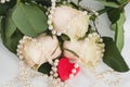 Red heart surrounded by roses and beads. Royalty Free Stock Photo