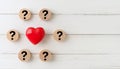 Red Heart Surrounded by Wooden Discs with Question Marks on White Rustic Background Royalty Free Stock Photo