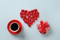 Red heart sweets, gift and cup of coffee on blue background. Valentine's day.