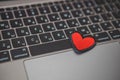 red heart symbol on laptop keyboard. online dating