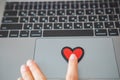 red heart symbol on laptop keyboard. online dating
